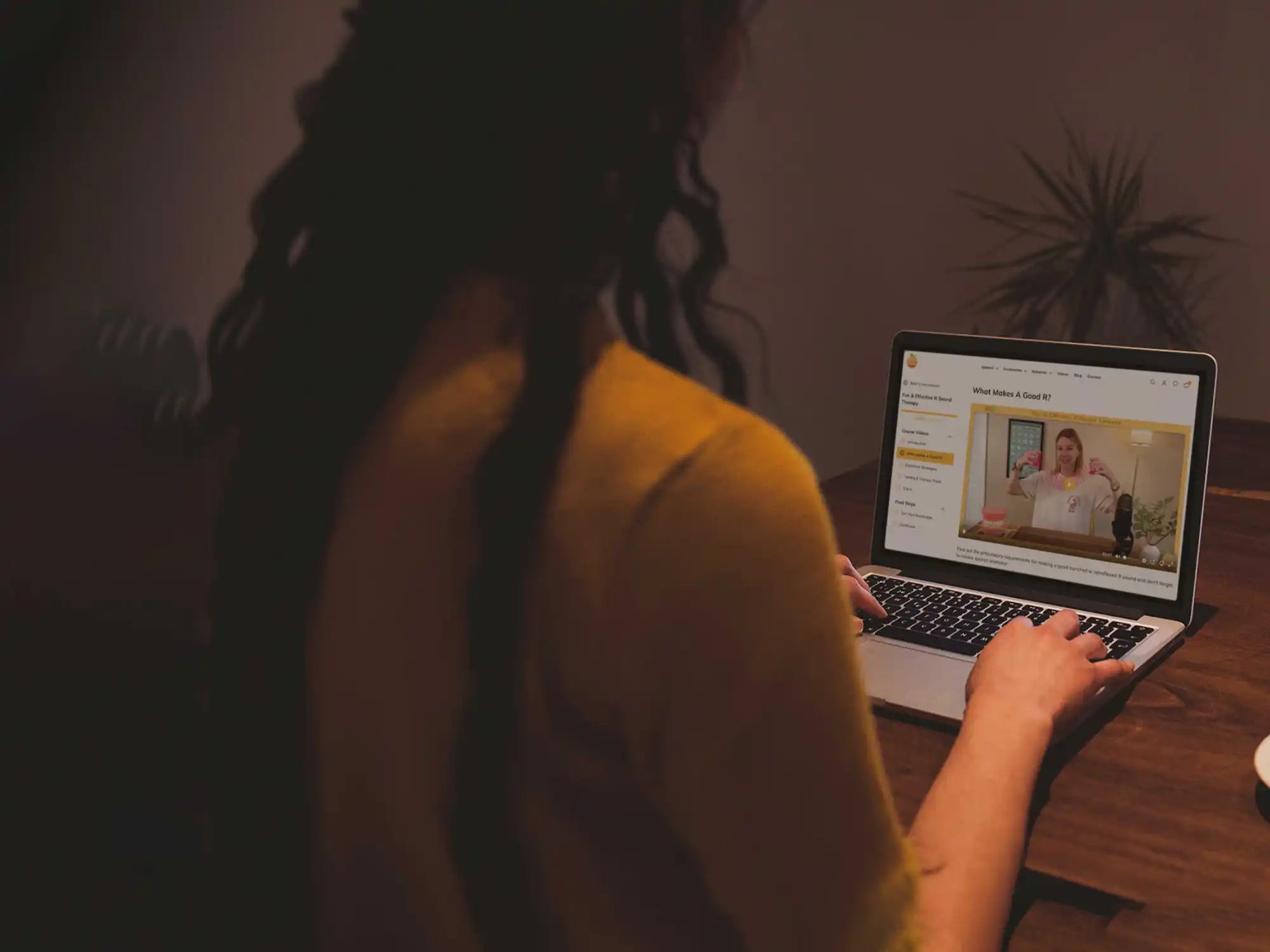A person using a laptop computer to watch an online video.