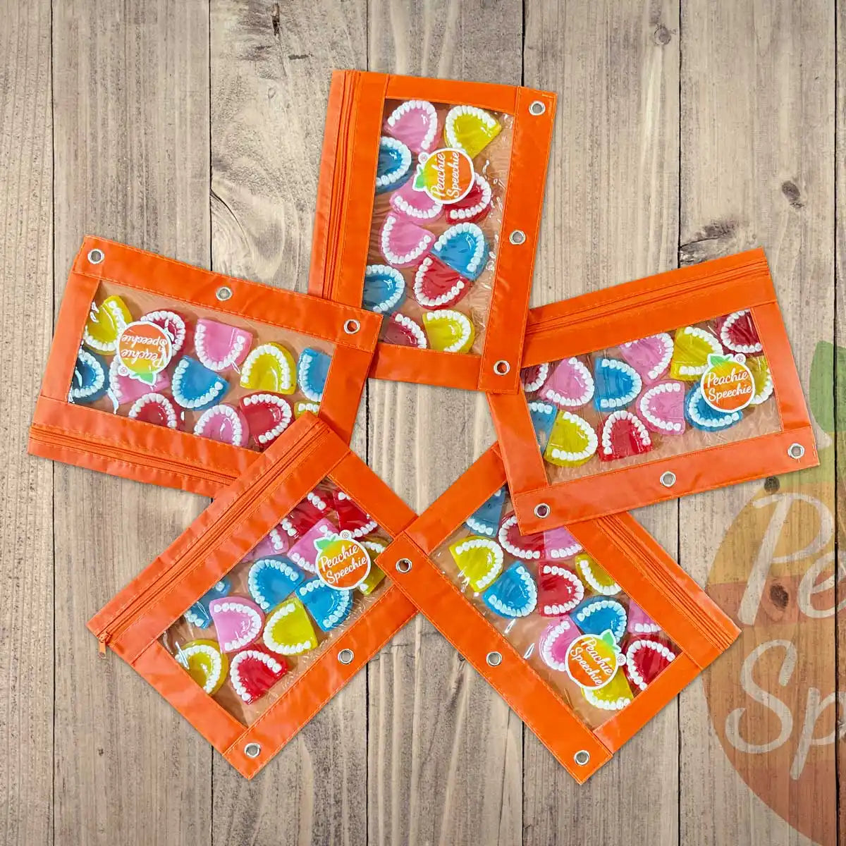 Five orange fabric wallets arranged in a star pattern with colorful heart print fabric inserts.