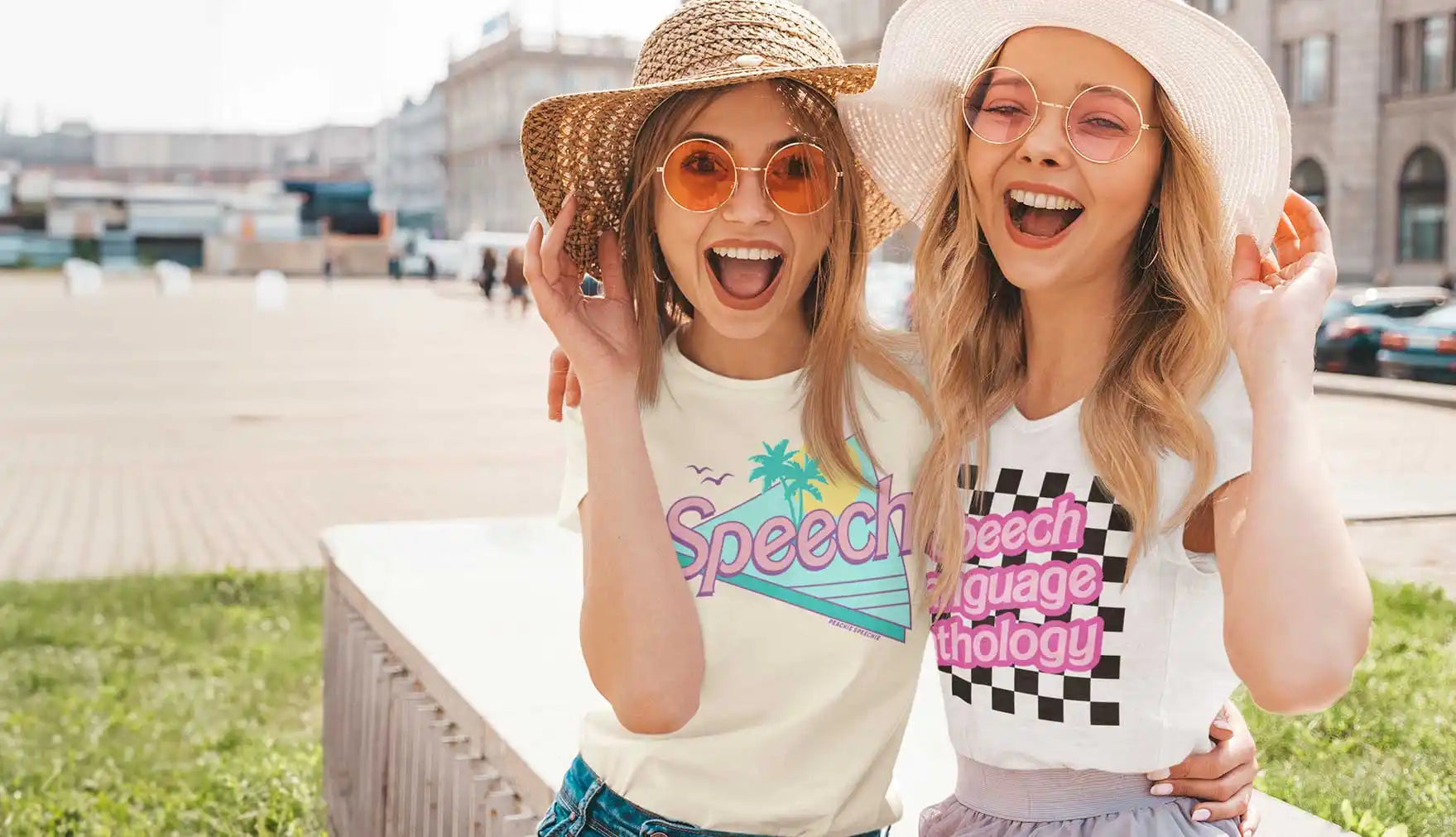 Two smiling young women wearing hats and sunglasses.