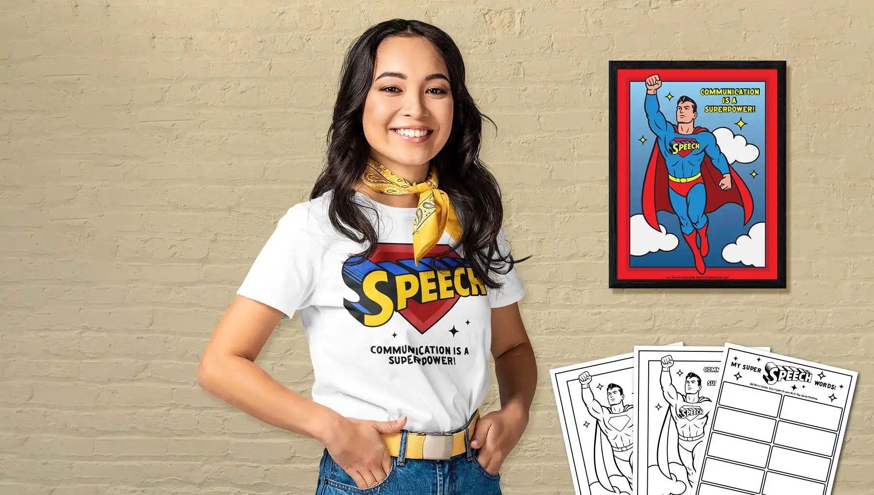 A young woman in a white ’Speech’ themed t-shirt and yellow bandana, surrounded by Superman-themed educational materials.
